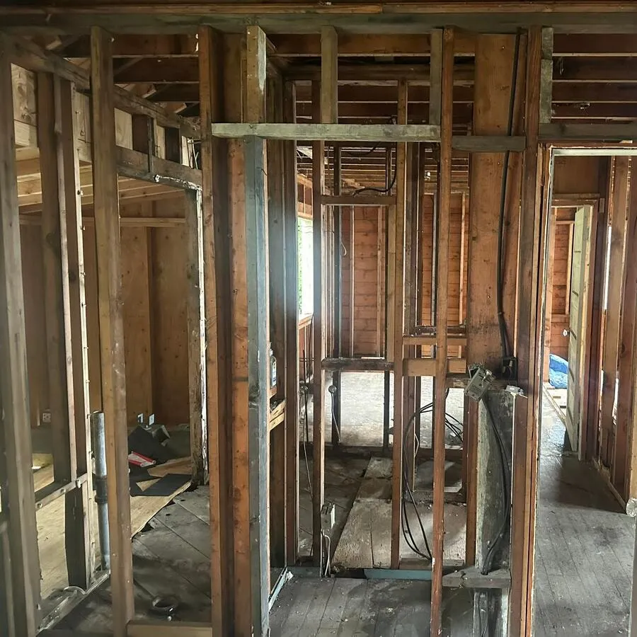 New wiring pulled through the open walls of an old house during a whole-home rewire