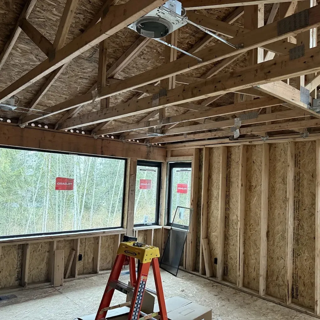 Recessed cans roughed into a new build ceiling, with a ladder set up below