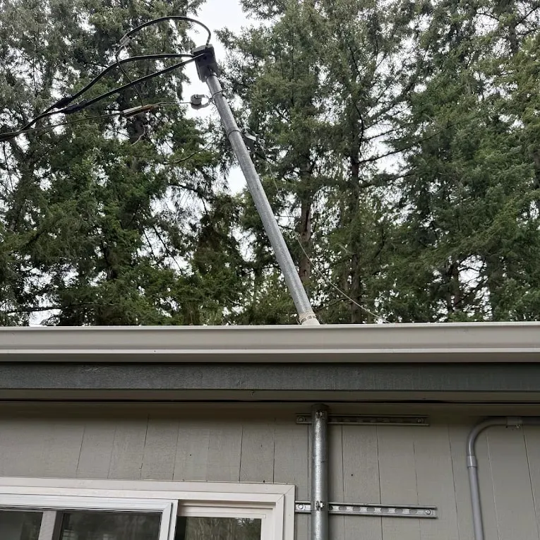 Damaged service mast pulled away from the house, before repair