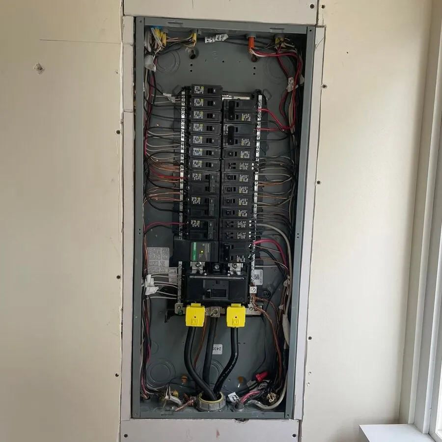 Completed panel upgrade with the deadfront off, showing the finished wiring