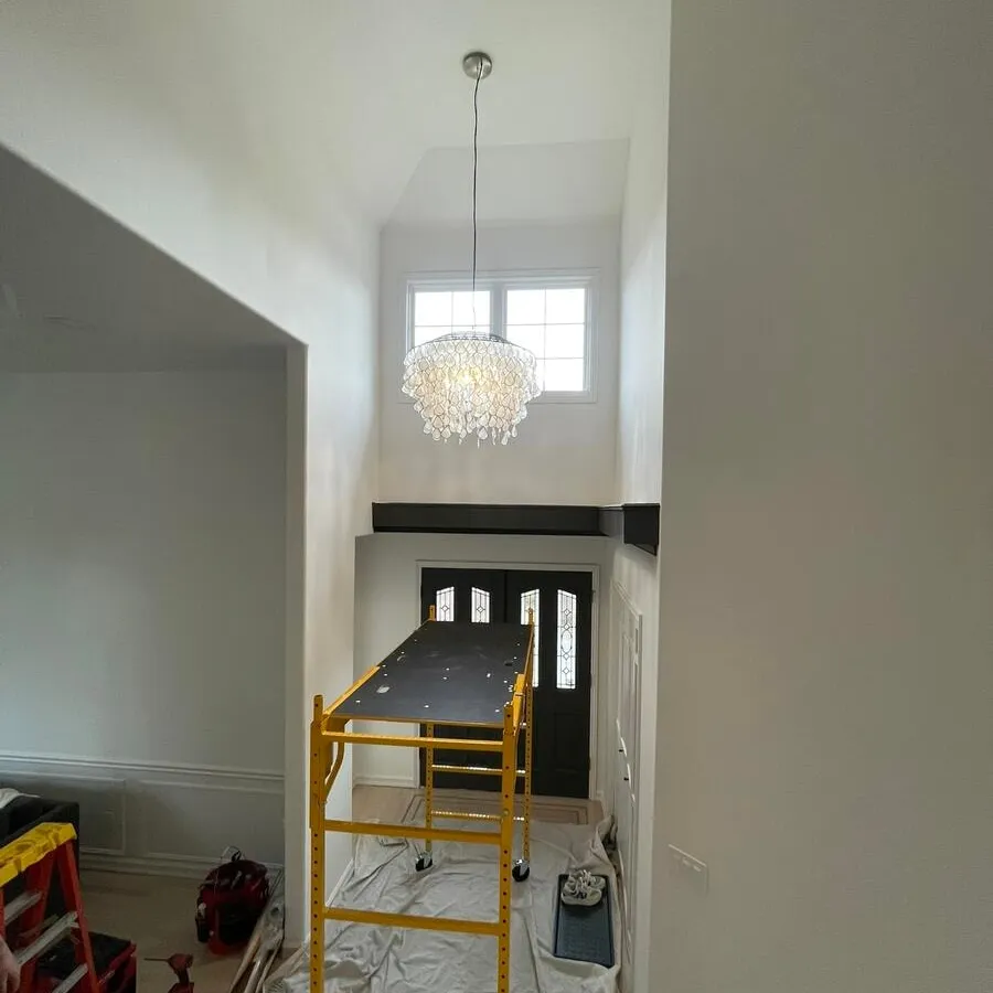 Newly hung chandelier above the scaffolding used to reach the ceiling