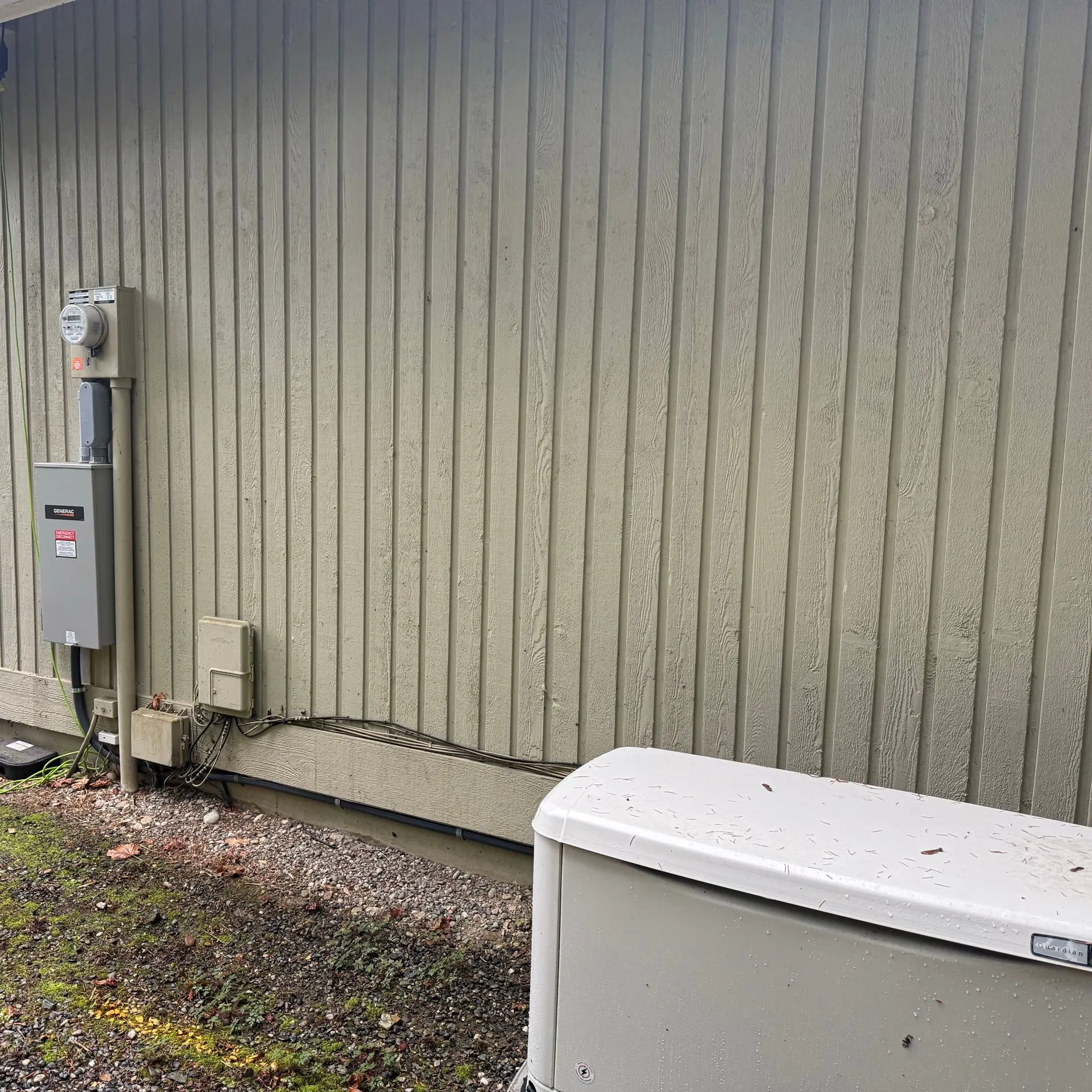 Completed Generac standby generator installation with the meter and transfer switch on the exterior wall