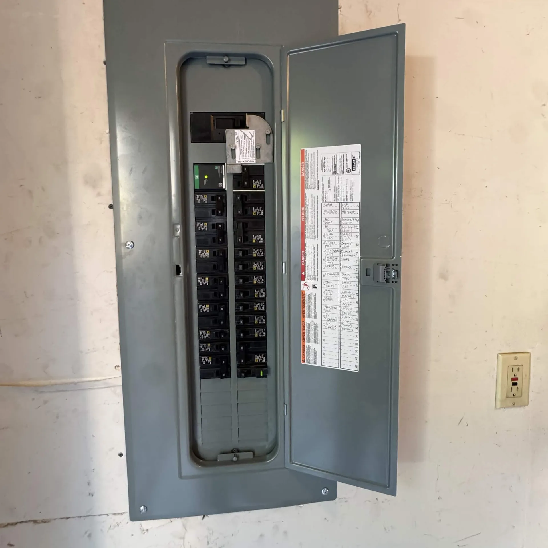Electrical panel with the door open, showing an installed generator interlock kit