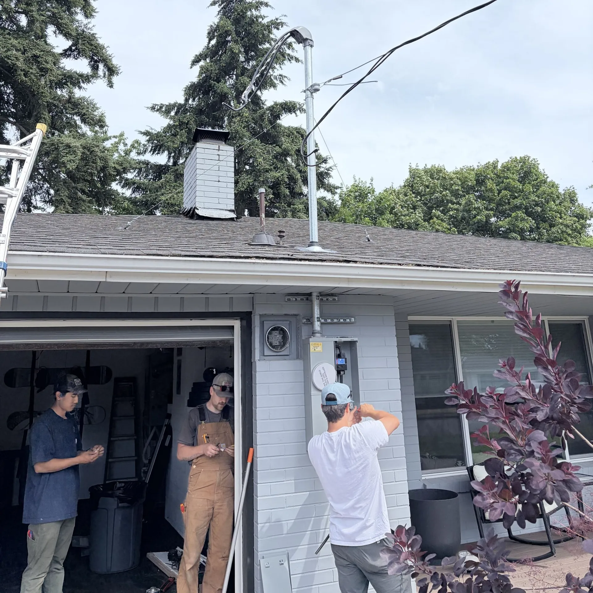 Crew working together on the panel and service entrance during an upgrade