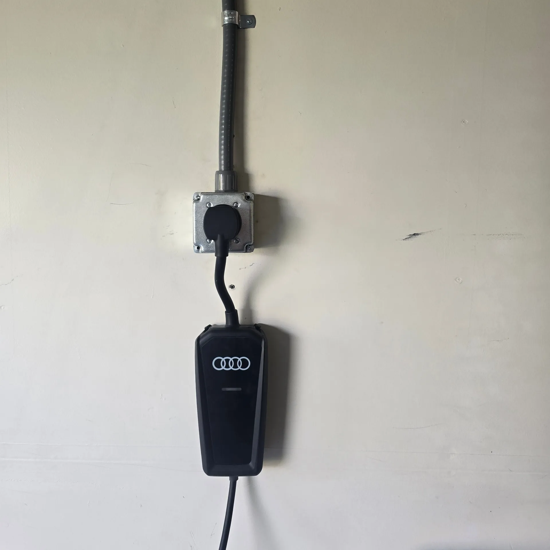 Audi portable EV charger plugged into a newly installed NEMA 14-50 outlet