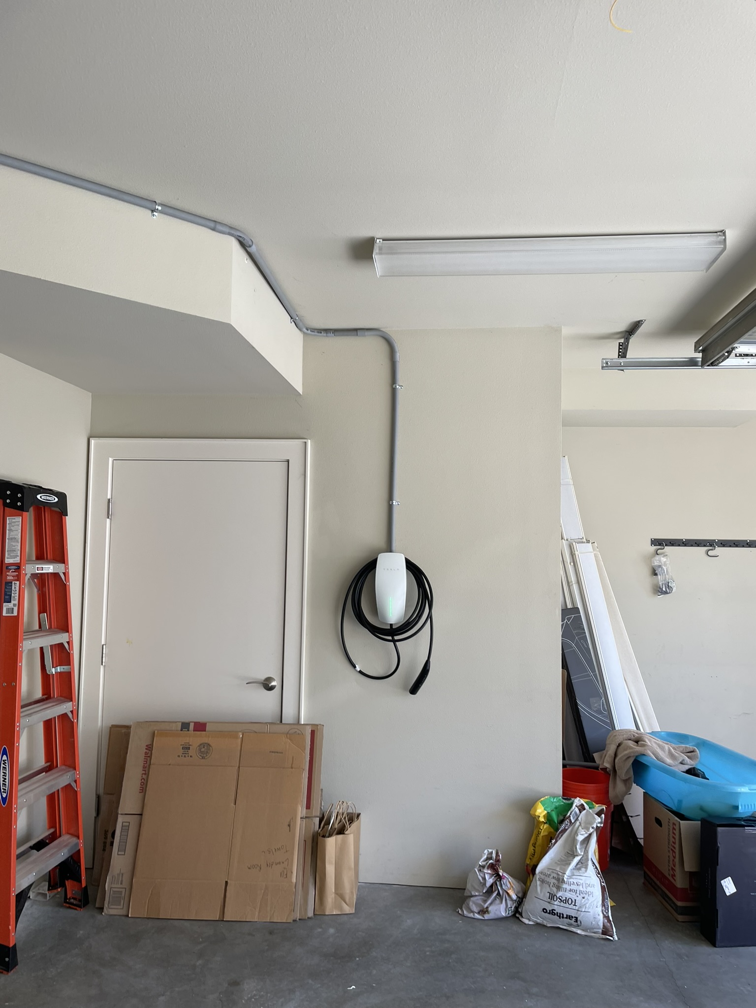 Completed EV charger installation mounted in garage