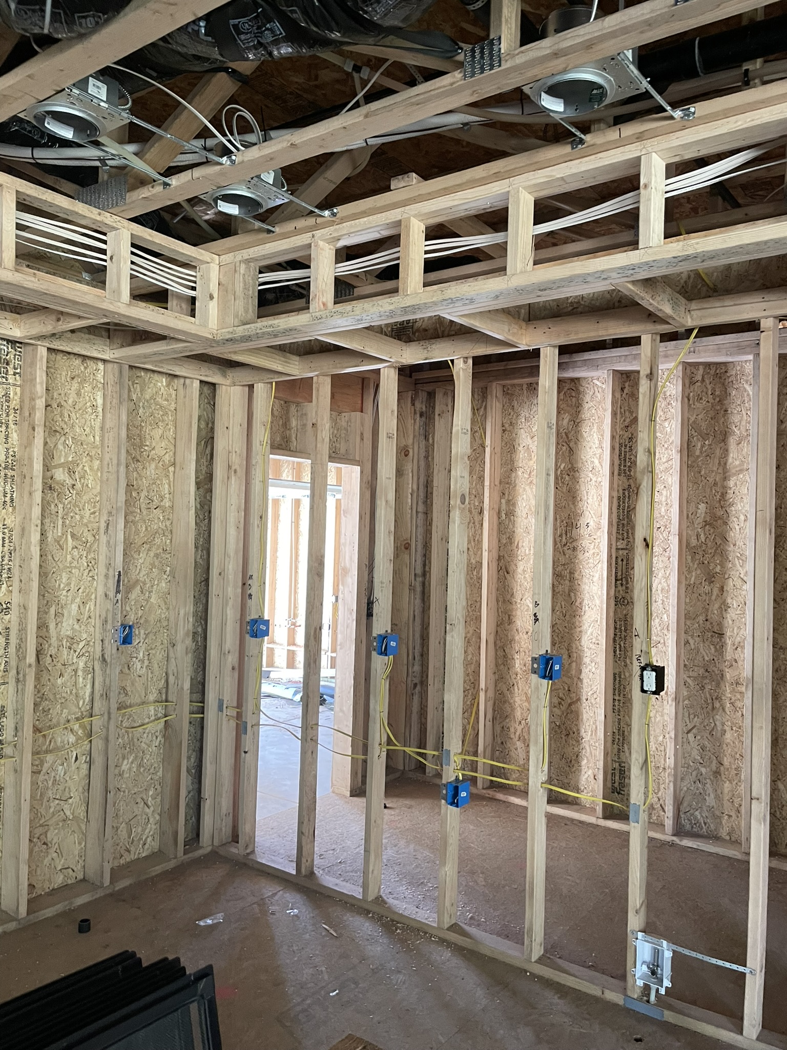 New construction room with rough-in electrical wiring visible