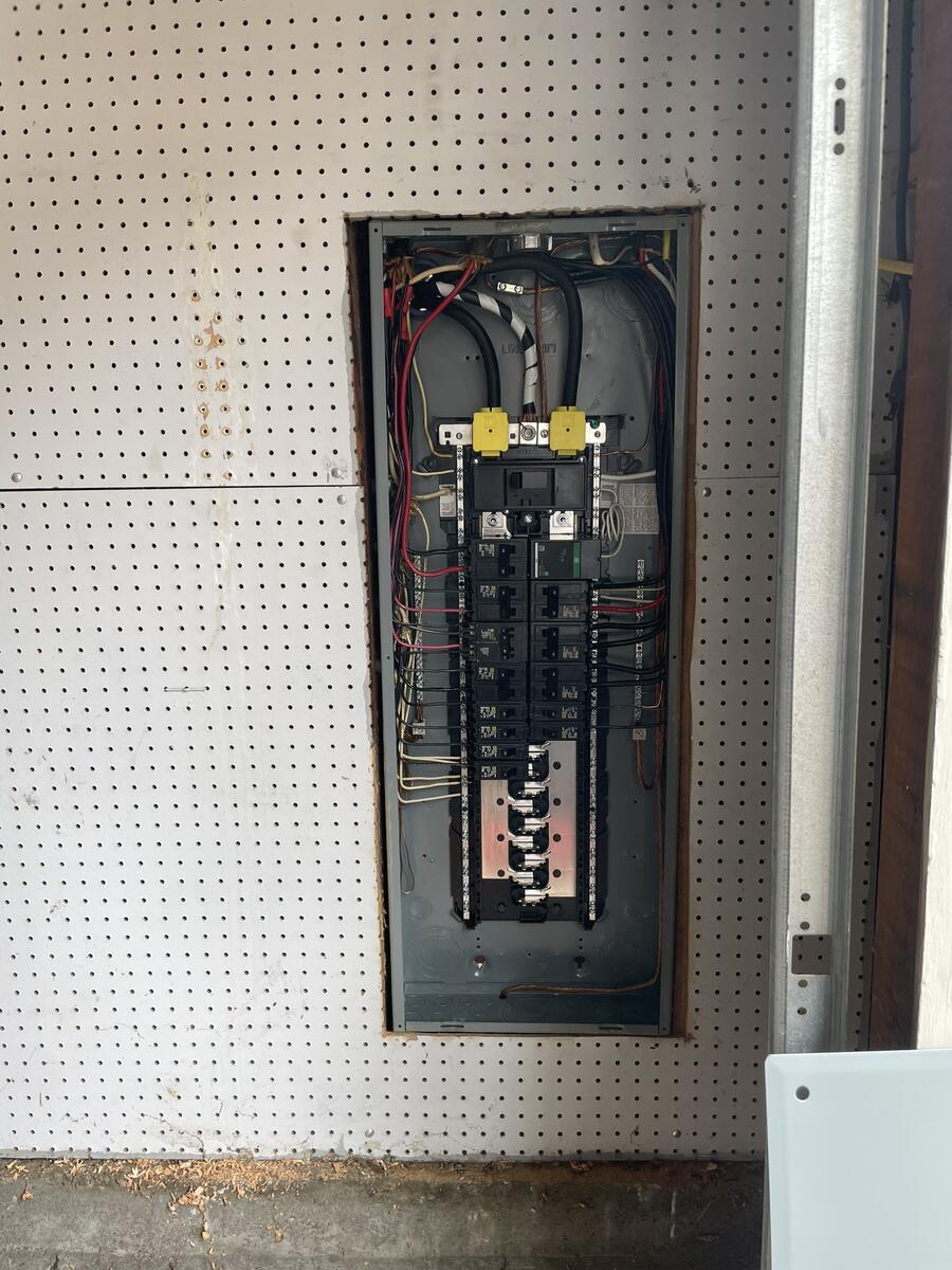New electrical panel installation with wires exposed during upgrade